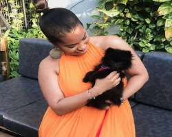 She has adopted a cute dog with whom she loves to play in her spare time.